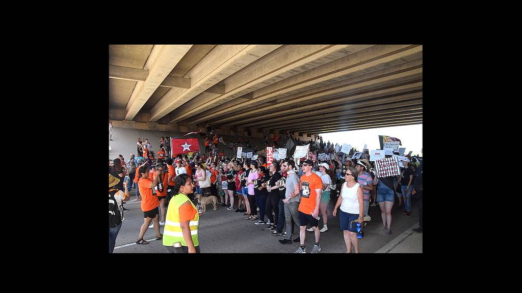 Protesters march to the Rogers Lane overpass after demonstrating at the North Sheridan Road gates of Fort Sill Saturday, July 20, 2019 in Lawton, Okla.