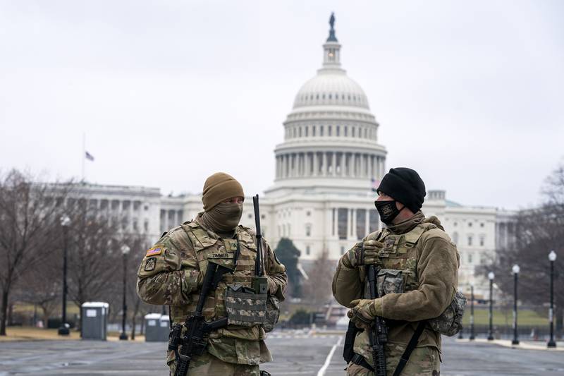 Members of the National Guard patrol the area outside of the U.S. Capitol on the third day of the second impeachment trial of former President Donald Trump, on Capitol Hill in Washington, Thursday, Feb. 11, 2021.