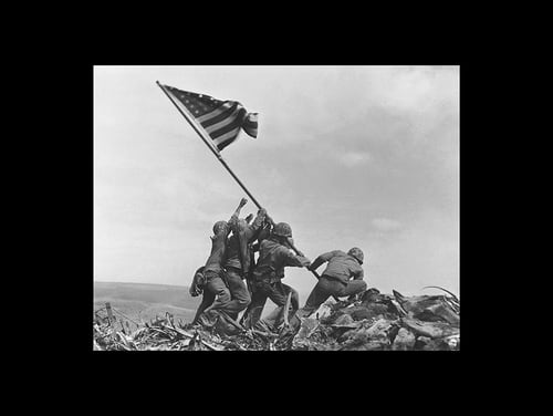 U.S. Marines of the 28th Regiment, 5th Division, raise the American flag atop Mt. Suribachi, Iwo Jima, on Feb. 23, 1945. (Joe Rosenthal/AP)