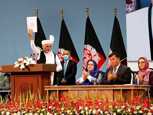Afghan President Ashraf Ghani holds up a resolution on the last day of an Afghan Loya Jirga or traditional council, in Kabul, Afghanistan, Sunday, Aug. 9, 2020. The council concluded Sunday with hundreds of delegates agreeing to free 400 Taliban members, paving the way for an early start to negotiations between Afghanistan's warring sides. (AP)