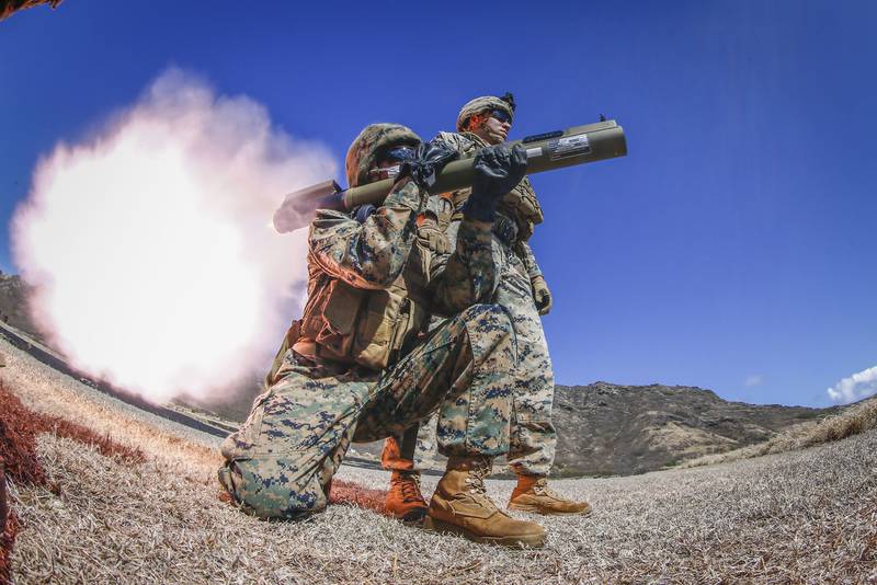 Sgt. Isaac Zimmerman observes as a Marine fire an M72 LAW weapon system at Marine Corps Base Hawaii, Aug. 13, 2020.