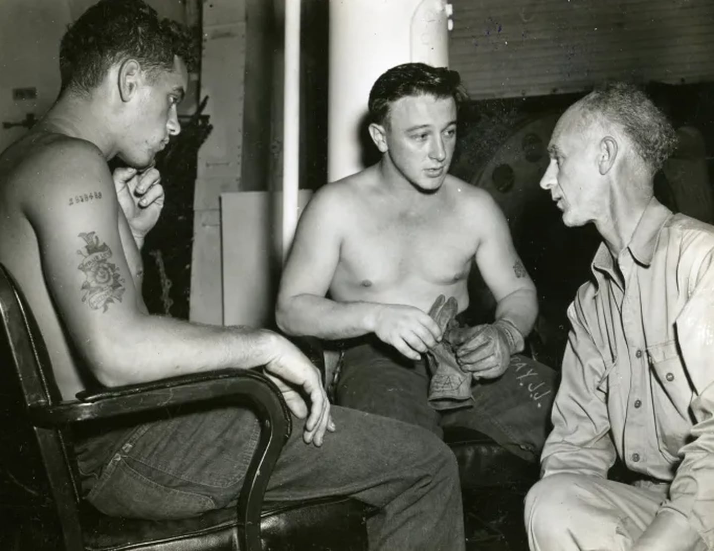 Ernie Pyle, war correspondent, interviews Joe J. Ray and Charles W. Page on board the USS Yorktown on Feb. 5, 1945.