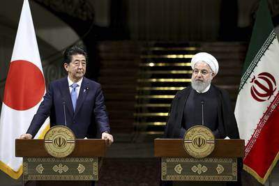 Iranian President Hassan Rouhani, right, speaks with media during a joint press conference with Japanese Prime Minister Shinzo Abe