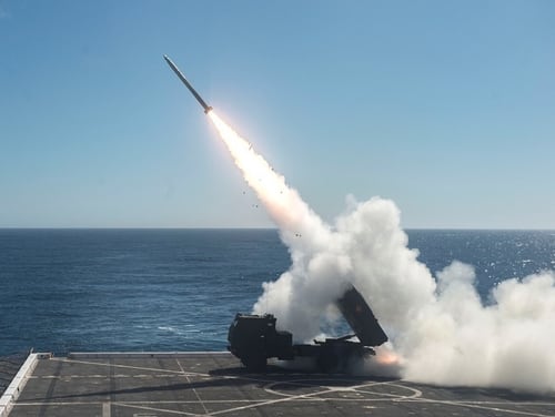 A High Mobility Artillery Rocket System is fired from the flight deck of the amphibious transport dock ship Anchorage on Oct. 22, 2017. (Mass Communication Specialist 2nd Class Matthew Dickinson/Navy)