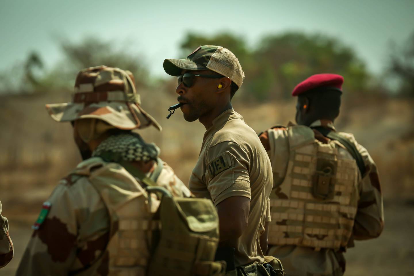 U.S. Army soldier blows a whistle to halt Mauritanian soldiers during dynamic shooting drills at Flintlock in Daboya, Ghana, March 9, 2023.