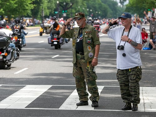 I veterani e fratelli Mark, a sinistra, e John Brancaccio, a destra, salutano i motociclisti mentre passano vicino al National Mall durante il Rolling Thunder Rally a Washington, 27 maggio 2018 (Alan Lessig / Staff)