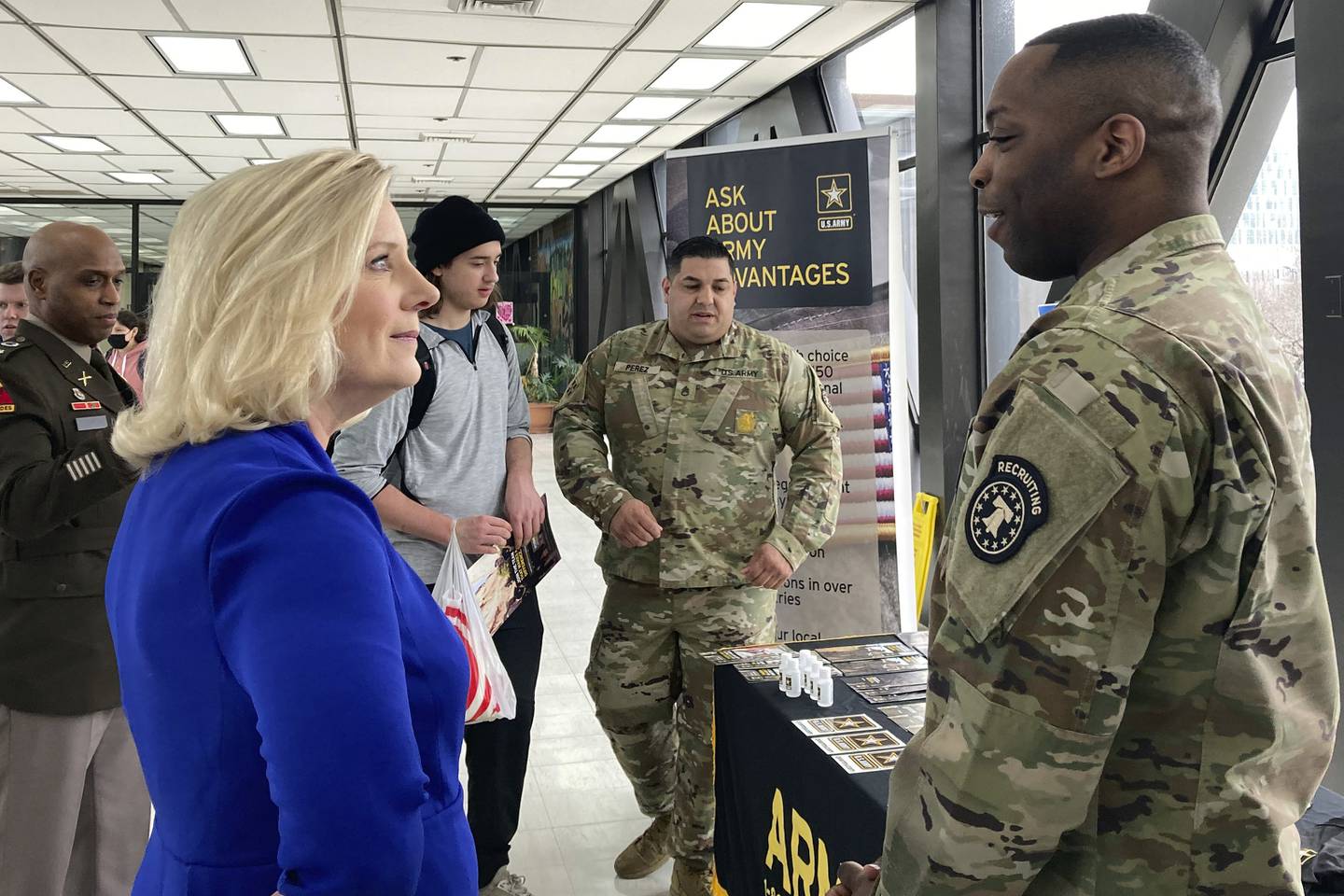 Army Secretary Christine Wormuth stops at an Army recruiting display after a speech to students at the Whitney M. Young Magnet High School in Chicago, on Feb. 14, 2023.