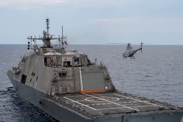 An MQ-8B Fire Scout UAV conducts flight operations alongside the Freedom-class LCS Milwaukee in the Atlantic Ocean. (MC2 Anderson Branch/U.S. Navy)