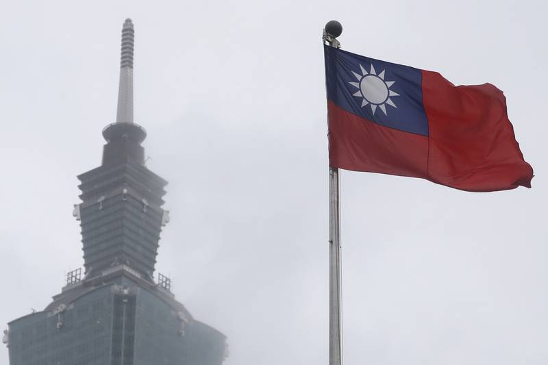 A Taiwan national flag flutters near the Taipei 101 building at the National Dr. Sun Yat-Sen Memorial Hall in Taipei, Taiwan, on May 7, 2023.