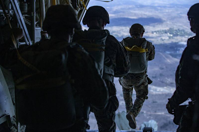 Marines static line jump from a KC-130J Hercules over Drop Zone Basilone during a parachute operation on Marine Corps Base Camp Pendleton, Calif., Dec. 10, 2020.