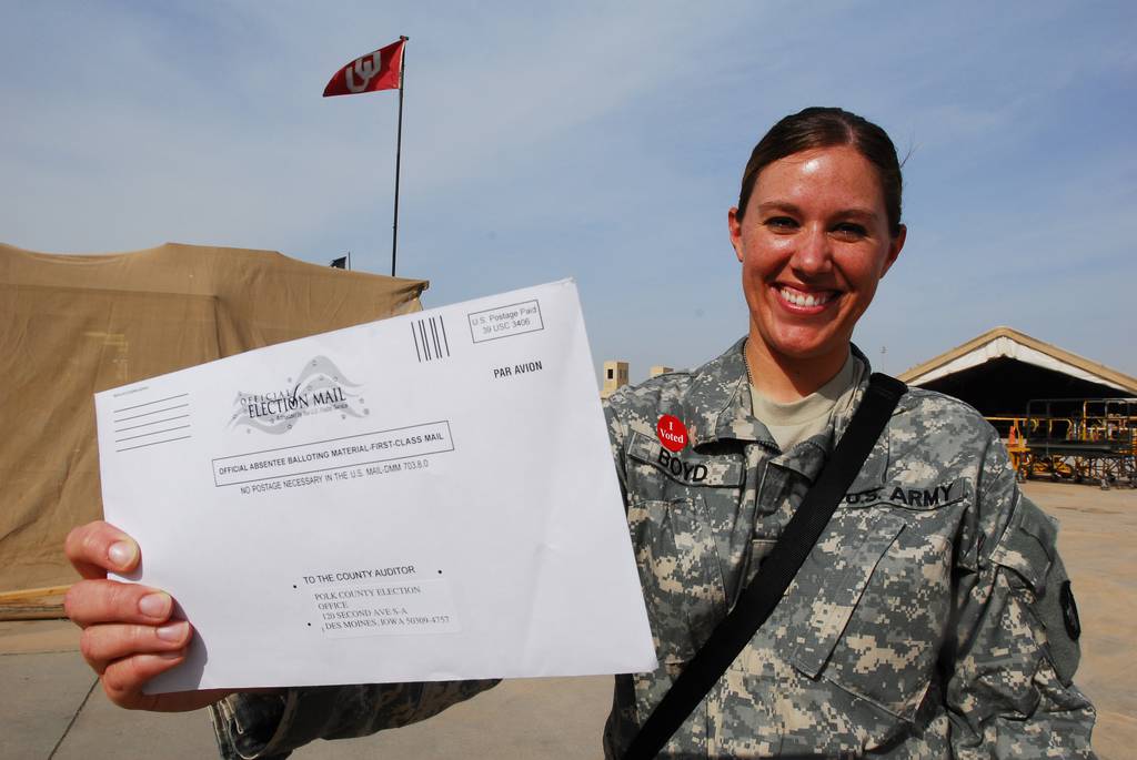 Spc. Andrea Boyd, aviation supply specialist of Task Force 34, B Company, 834th Aviation Support Battalion, holds the election ballot she received in the mail at Joint Base Balad, Iraq, in 2008.