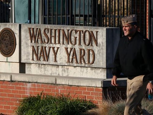 In this Sept. 19, 2013, file photo. military personnel walks past an entrance to the Washington Navy Yard in Washington. (Charles Dharapak/AP)