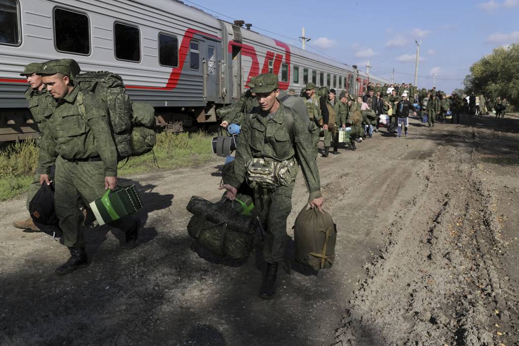 Russian recruits walk to take a train at a railway station in Prudboi, the Volgograd region of Russia, on Sept. 29, 2022.