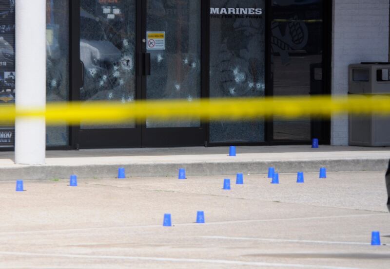The windows of the Armed Forces Recruitment Center have several bullet holes from a shooting as the area is cordoned off with blue shell casing markers in the parking lot on Thursday, July 16, 2015 in Chattanooga, Tenn. At least two military facilities in Tennessee were attacked in shootings Thursday. (Tim Barber/Chattanooga Times Free Press via AP) THE DAILY CITIZEN OUT; NOOGA.COM OUT; CLEVELAND DAILY BANNER OUT; LOCAL INTERNET OUT; MANDATORY CREDIT