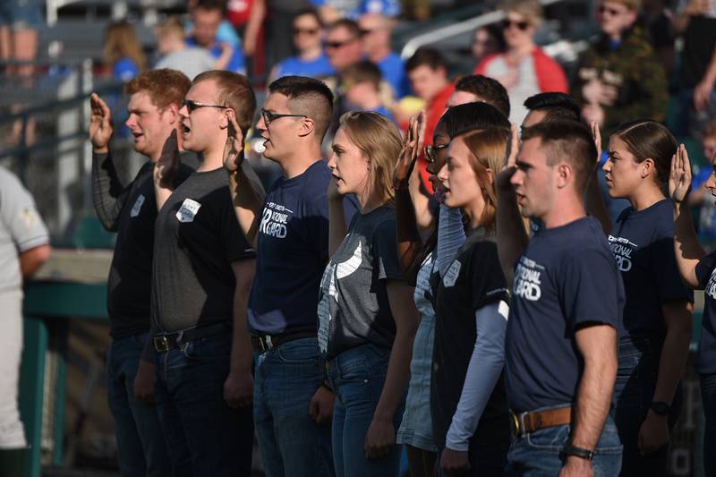 Recent enlistees in various branches of the U.S. military recite the oath of enlistment during a commitment ceremony at the Military Appreciation Night for the Fargo-Moorhead RedHawks baseball game on June 18, 2019, at Newman Outdoor Field, Fargo, N.D.