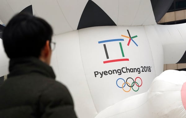 In this Dec. 29, 2017, photo, a man walks by the official emblem of the 2018 Pyeongchang Olympic Winter Games, in downtown Seoul, South Korea.(Lee Jin-man/AP)