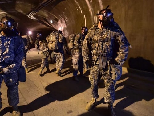 Soldiers wearing gas masks stand in a tunnel during a competition to test individual skills at Uijeongbu, South Korea. (Jung Yeon-Je/AFP/Getty Images)