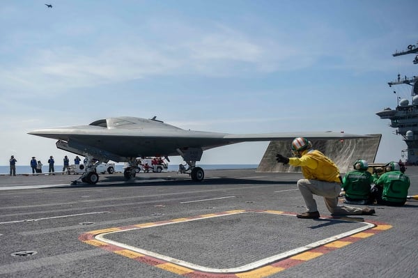 The Navy's unmanned X-47B launches from the aircraft carrier Theodore Roosevelt in 2014. The unmanned aircraft evolved into the current MQ-25 Stingray tanker program, but the Navy will need to hike unmanned aircraft to save the carrier from irrelevance, experts say. (Navy)