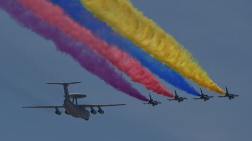 A Chinese People's Liberation Army Air Force KJ-2000 airborne early warning and control aircraft, left, flies in formation with Chengdu J-10 multirole fighter aircraft during a military parade at Tiananmen Square in Beijing. Chengdu J-10 fighter jets landed at Singapore’s Changi East Airbase on Feb. 4, 2019, ahead of the Singapore Airshow. (Greg Baker/AFP via Getty Images)