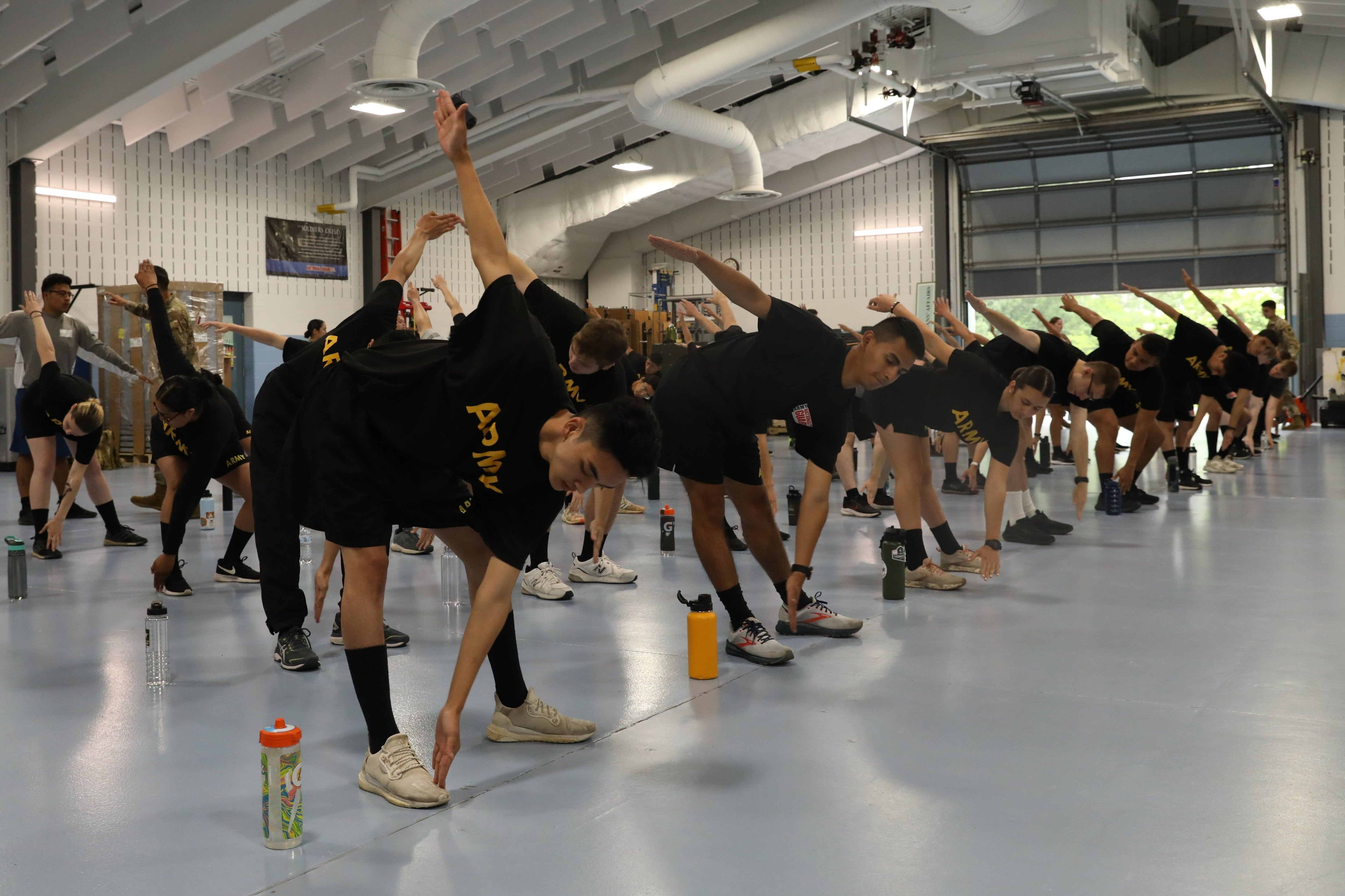 Recruits assigned to the recruit sustainment program for the Illinois Army National Guard conduct PT at the Woodstock Armory, June 12, 2022. (Cpl. Shaylin Quaid/Army)