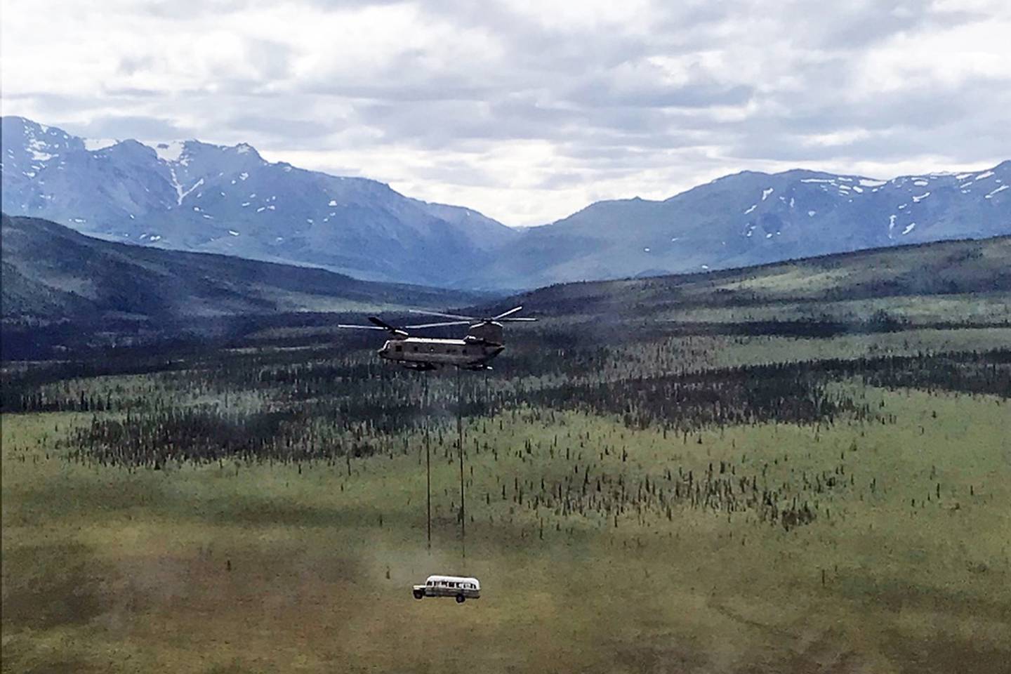 In this photo released by the Alaska National Guard, Alaska Army National Guard soldiers use a CH-47 Chinook helicopter to airlift an abandoned bus, popularized by the book and movie "Into the Wild," out of its location in the Alaska backcountry in light of public safety concerns, as part of a training mission Thursday, June 18, 2020.
