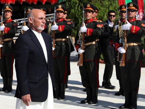 Afghan President Ashraf Ghani inspects the honor guard during Independence Day celebrations at Defense Ministry in Kabul, Afghanistan, Monday, Aug. 19, 2019. (Afghan Presidential Palace via AP)