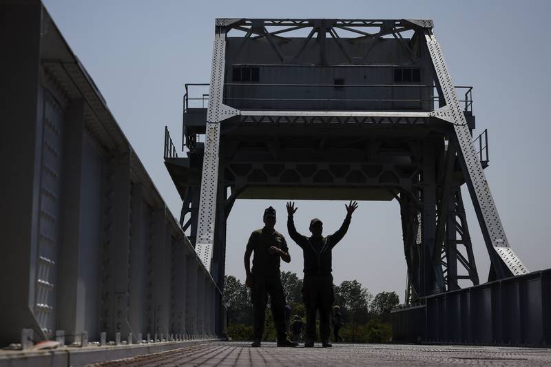 Servicemen walk on Pegasus Bridge, one of the first sites liberated by Allied forces from Nazi Germany, in Benouville, Normandy, Monday June 5, 2023.