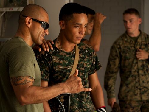 A Marines offers feedback to a Guatemalan marine who is learning how to teach room clearing to his juniors. The Marines deploy to Puerto Barrios, Guatemala for six months at a time to work with the members of the new force tasked with fighting drug traffickers. Mike Morones/Staff