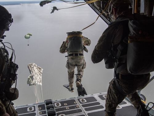 Air Force Special Tactics operators conduct a static line jump out of a C-130H Hercules following a Rigged Alternate Method Boat package into the water during training at Eglin Range, Fla., Aug. 21, 2020. (Tech. Sgt. Rose Gudex/Air Force)