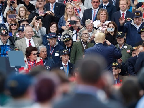 President Donald Trump is considering Veterans Day pardons for some service members charged with or convicted of war crimes, but Pentagon officials say Defense Secretary Mark Esper will ask him to reconsider. Pictured: Trump salutes to veterans prior to a ceremony to mark the 75th anniversary of D-Day at the Normandy American Cemetery in Colleville-sur-Mer, Normandy, France, on June 6, 2019. (Thibault Camus/AP)