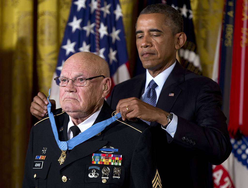 In this Sept. 15, 2014, file photo, then-President Barack Obama bestows the Medal of Honor on retired Army Command Sgt. Maj. Bennie G. Adkins in the East Room of the White House in Washington.