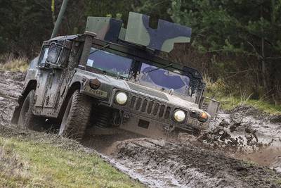 Soldiers maneuver a Humvee through a driver’s training terrain course as part of the basic driving class at the 7th Army Training Command’s Grafenwoehr Training Area, Germany, Jan. 9, 2018