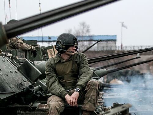 A U.S. Army infantryman waits atop an M2 Bradley fighting vehicle for the start of a live fire training exercise at Presidenski Range in Trzebian, Poland, March 26, 2018. (Spc. Dustin Biven/Army)