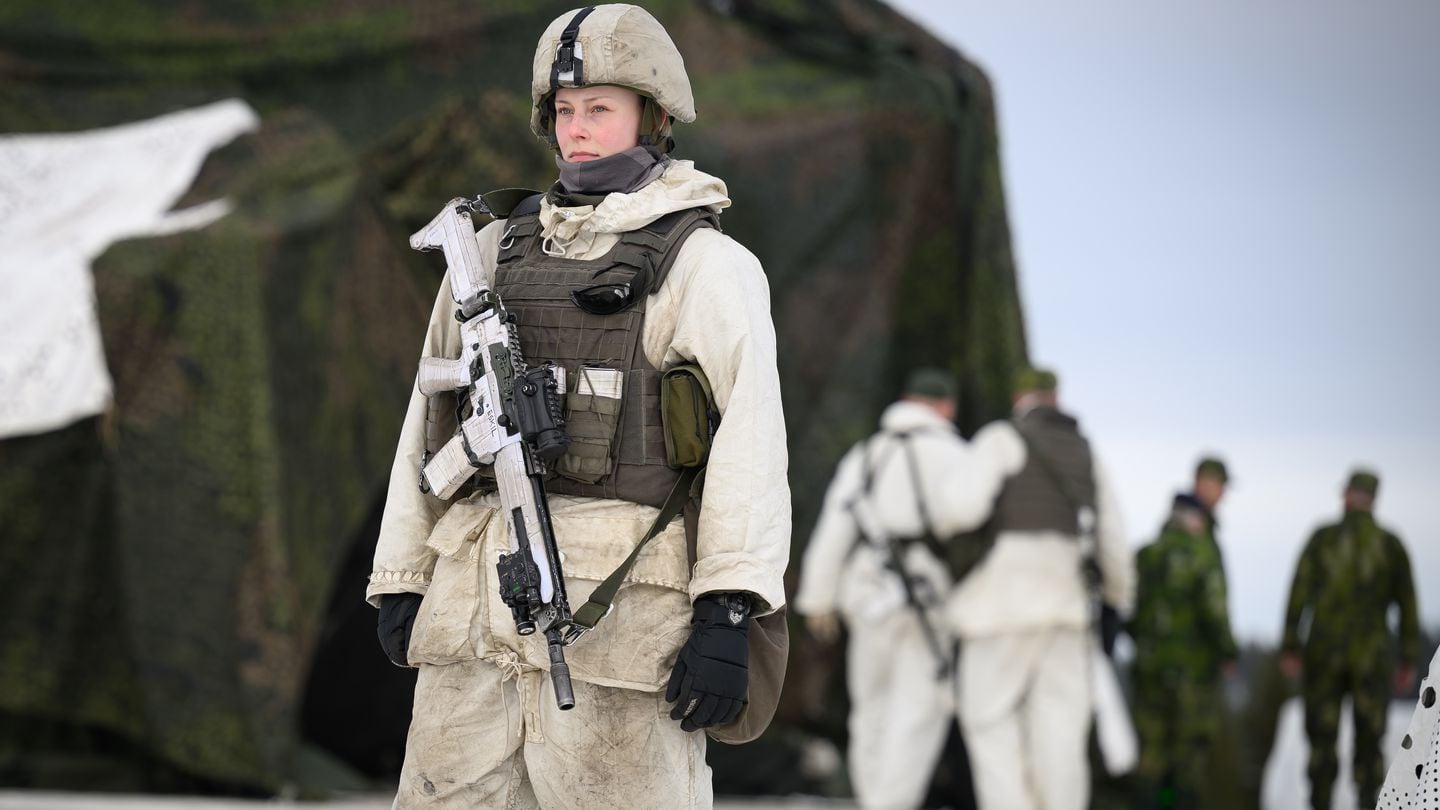 A member of a Swedish logistics regiment stands sentry at a supply depot during the Nordic Response exercise on March 8, 2024, near Enontekio, Finland. The drill involved 20,000 troops from 13 allied countries. (Leon Neal/Getty Images)