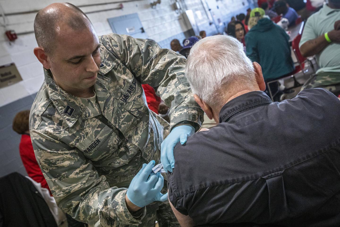 Air Force Capt. Kerwin Barden, chief nurse, 177th Fighter Wing, New Jersey Air National Guard, gives an unhoused veteran a flu shot in Cherry Hill, New Jersey, in 2019.