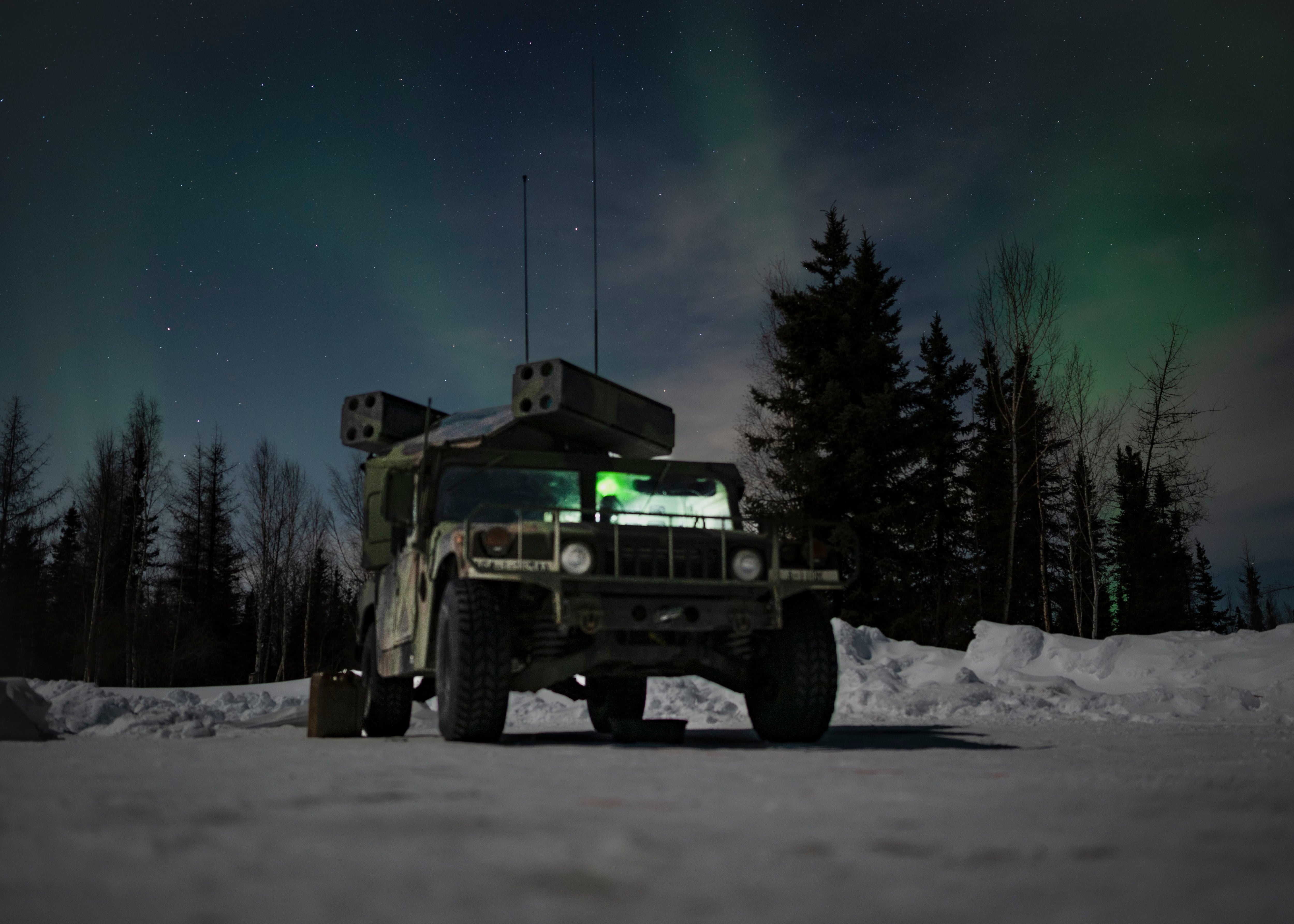 The northern lights glow above an Avenger air defense system during the Arctic Edge exercise at Eielson Air Force Base, Alaska, on March 11, 2022. (Staff Sgt. Dylan Murakami/U.S. Air Force)