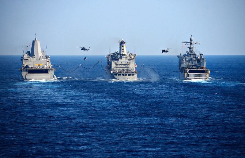 The transport dock ship Green Bay, the Military Sealift Command fleet replenishment oiler USNS Walter S. Diehl and the amphibious dock landing ship Ashland conduct a replenishment at sea with MH-60S Seahawk helicopters on Jan. 30, 2019, in the Philippine Sea. (MC1 Daniel Barker/Navy)