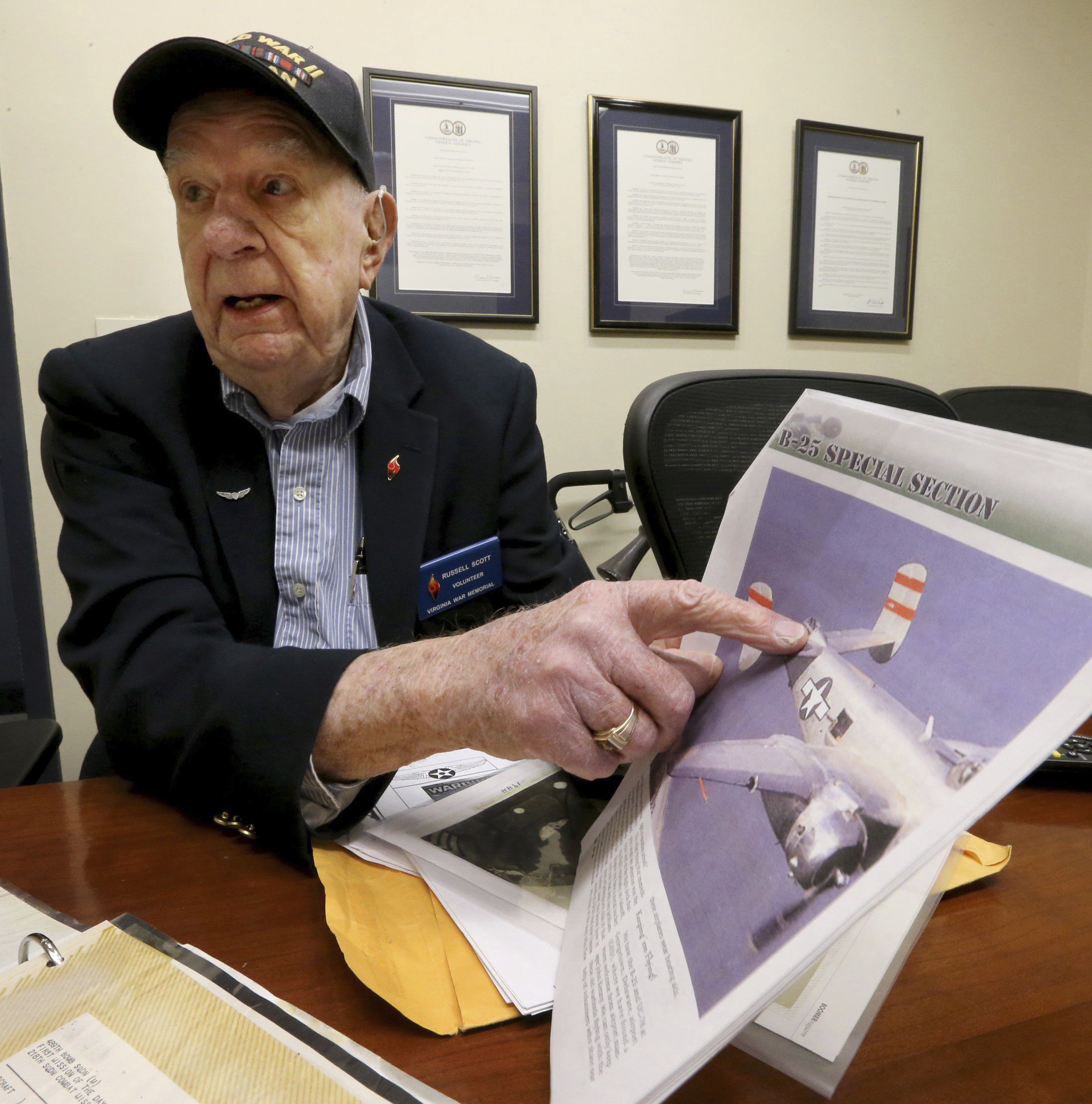 Former WWII POW Russell Scott points to the tail gunner position on a B25J during an interview at the Virginia War Memorial in Richmond, Va., Wednesday, March 26, 2014. (Bob Brown/Richmond Times-Dispatch via AP)