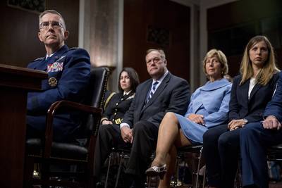 Gen. John Hyten, left, accompanied by members of his family, including his wife Laura, second from right, and his daughter Katie, right, appears before the Senate Armed Services Committee on Capitol Hill in Washington, Tuesday, July 30, 2019, for his confirmation hearing to be vice chairman of the Joint Chiefs of Staff.