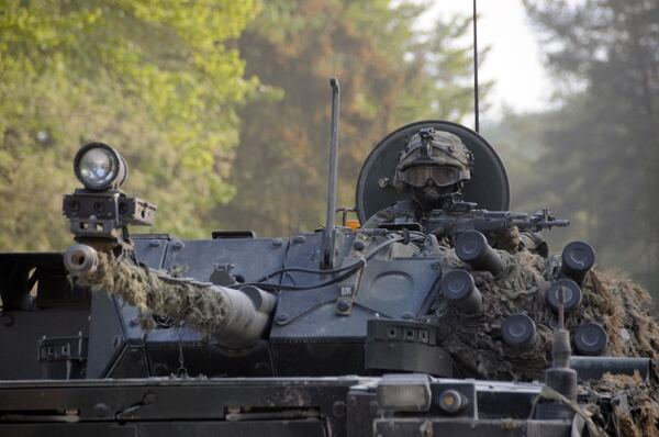 A Polish Army soldier scans his surroundings from the turret of a Rosomak infantry fighting vehicle while conducting a mission in the Hohenfels Training Area, Hohenfels, Germany. (Sgt. Brian Schroeder/Army)