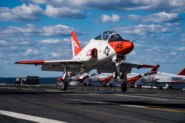 A T-45C Goshawk assigned to Carrier Training Wing 1 in 2017 performs a touch-and-go on the flight deck of the aircraft carrier Dwight D. Eisenhower while Ike was underway in the Atlantic Ocean. (Navy)