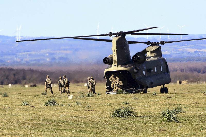Soldiers conduct a simulated air assault from an Army CH-47 Chinook during training at Monte Romano Training Area, Italy, Jan. 27, 2021.