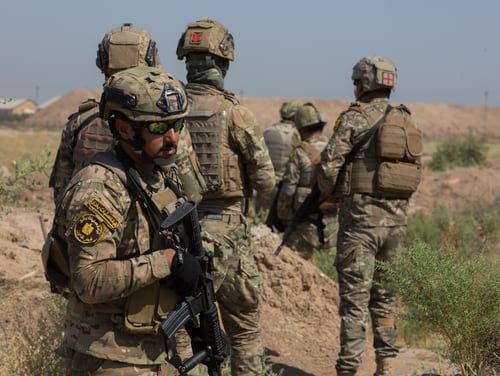 Iraqi soldiers conduct squad movement drills at Camp Taji, Iraq, July 23, 2019. Spanish and U.S. instructors train Iraqi Security Forces (ISF) in small unit tactics and techniques such as securing a helicopter landing zone, movement techniques, and crossing danger areas. (U.S. Army Reserve photo by Sgt. William Ploeg)