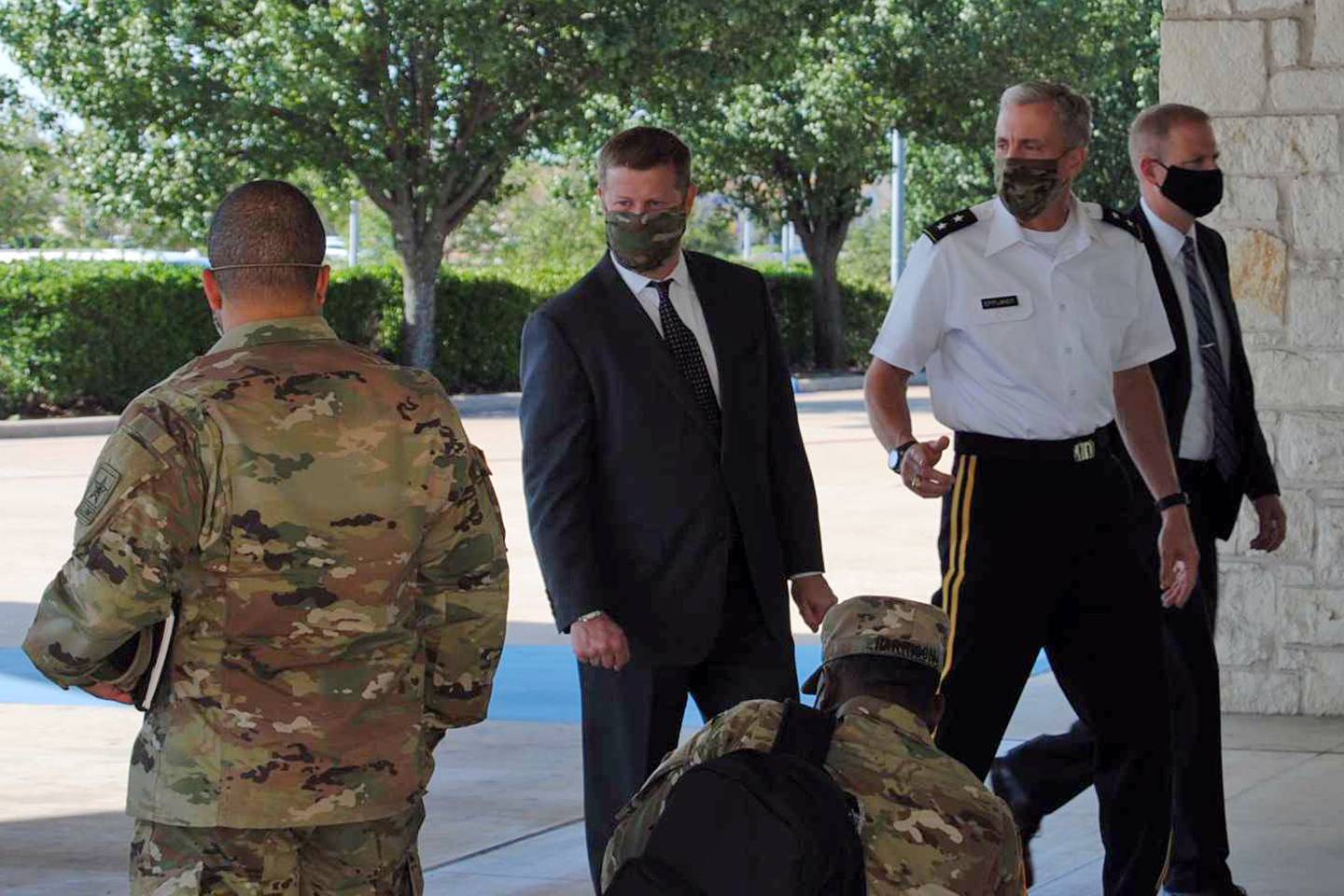 Secretary of the Army Ryan McCarthy, center, into the Killeen Civic and Conference Center on Aug. 6, 2020, ahead of a meeting with local officials in Killeen, Texas.