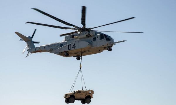 A CH-53K King Stallion lifts a Joint Light Tactical Vehicle during a demonstration, Jan. 18. Using the single point hook, the helicopter hovered up to 100 feet for approximately 10 minutes while carrying the 18,870-pound vehicle. (Navy)
