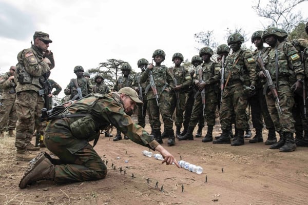 A member of the Dutch Army uses a sand table to give feedback to members of the Rwanda Defence Force following their run of convoy operations training as part of Exercise Shared Accord 2019, in Gabiro, Rwanda Aug. 23, 2019. (Sgt. Heather Doppke/Army)