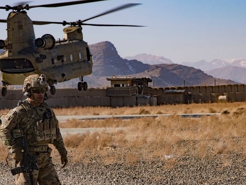 U.S. Army Capt. Bradley D. Rager, assigned to the Headquarters and Headquarters Battalion, 1st Armored Division, helps secure the helicopter landing zone as a CH-47 Chinook helicopter prepares to land at an Afghan military base Dec. 14, 2019, in southeastern Afghanistan. (Master Sgt. Alejandro Licea/Army)