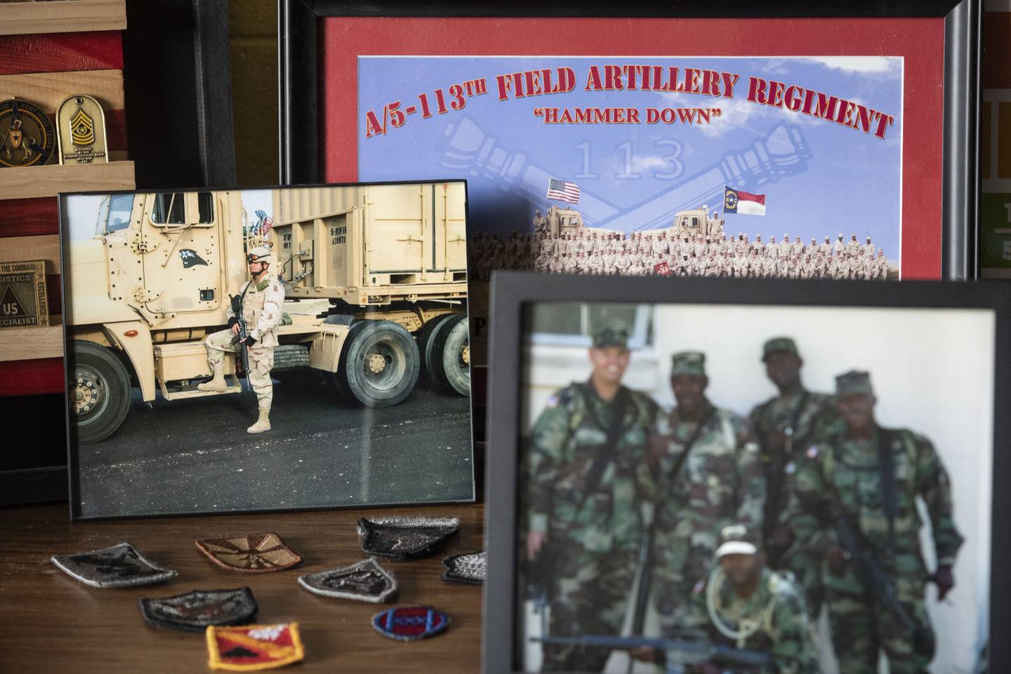 Various photos of Christopher Simmons while he served in the Army are displayed on a desk on Thursday, Oct. 27, 2022, at Meadowlark Middle School in Winston-Salem, N.C.