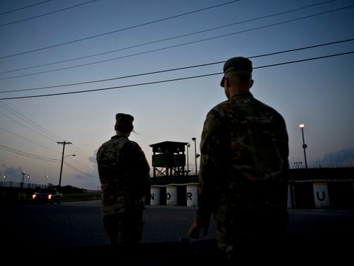 In this Tuesday, June 5, 2018, photo, reviewed by U.S. military officials, troops stand guard outside Camp Delta at the Guantanamo Bay detention center, in Cuba. (Ramon Espinosa/AP)