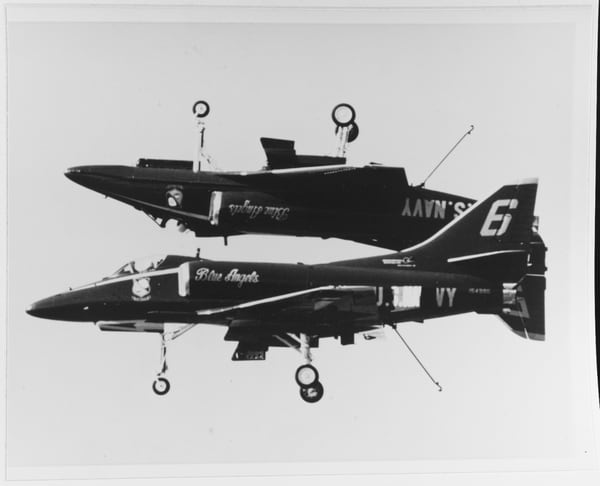 Two A-4F Skyhawks pass by in an upside-down formation, during a Blue Angels show. (National Archives)